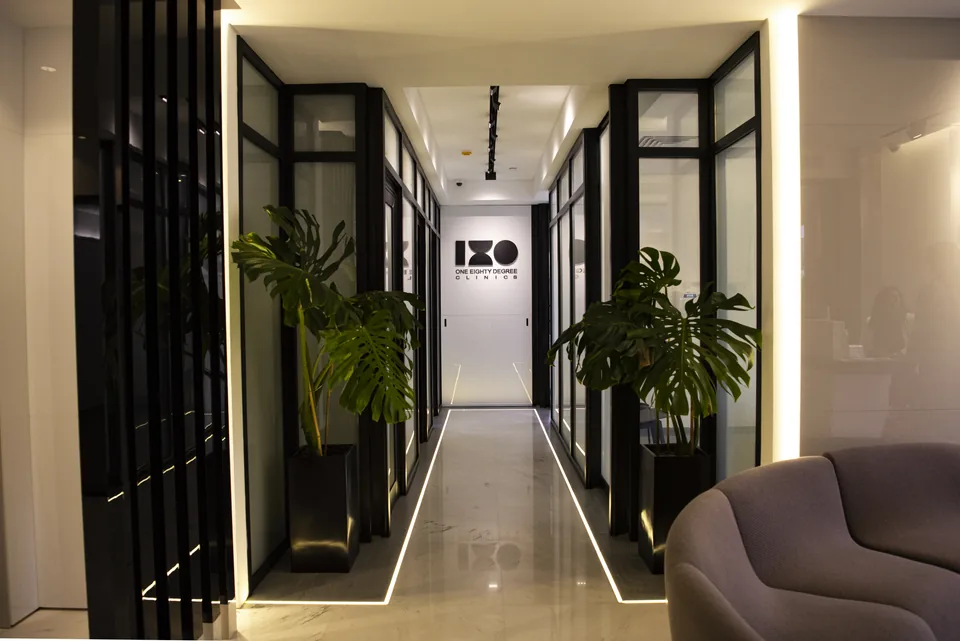 The clinic corridor, with plants and glass-fronted rooms