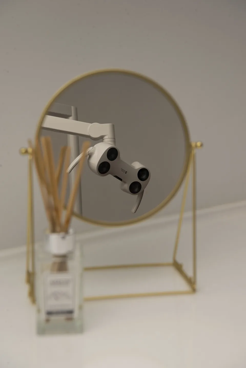 The clinic's dental microscope reflected in a mirror
